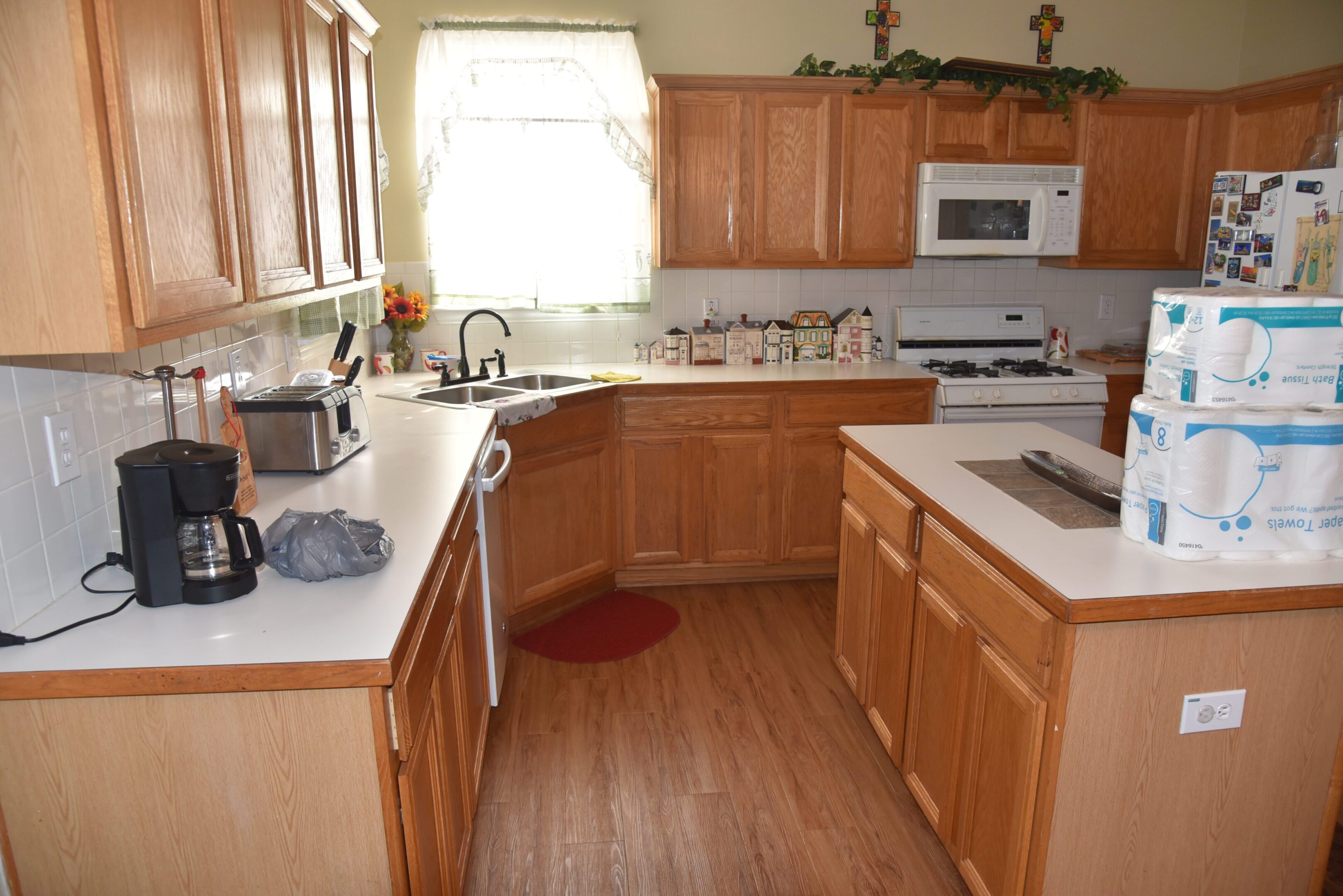 Wooden kitchen with appliances and countertops.