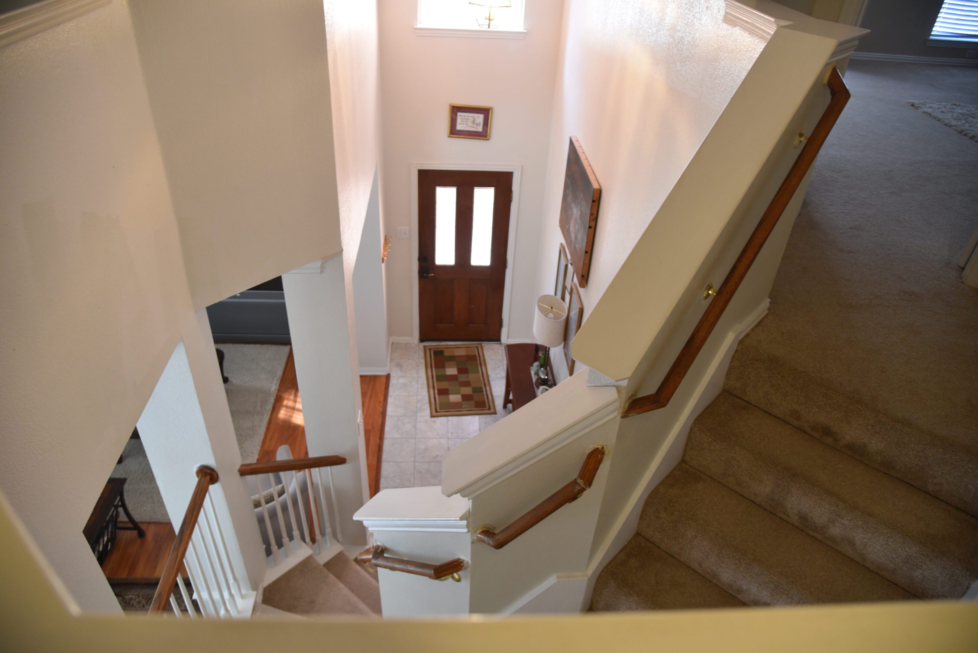 Two-story home with staircase and entryway.