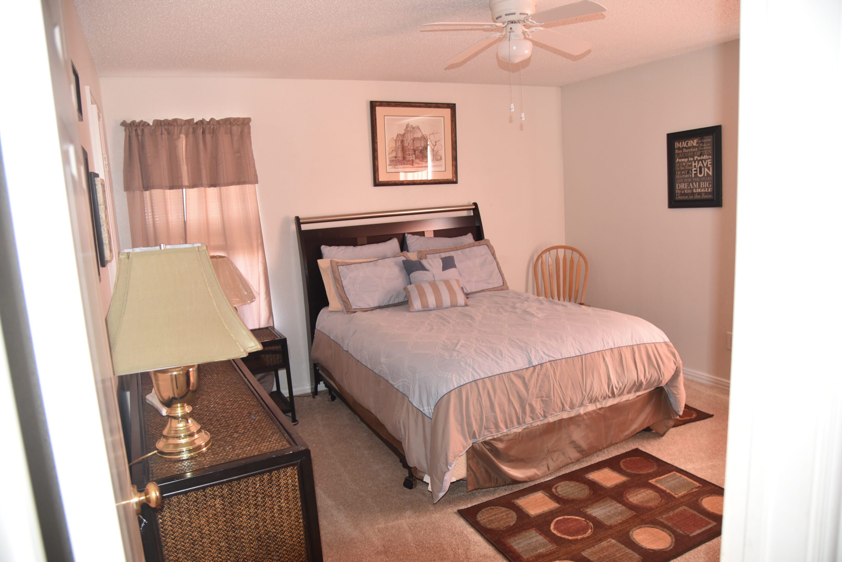 Cozy bedroom with bed and decor items.