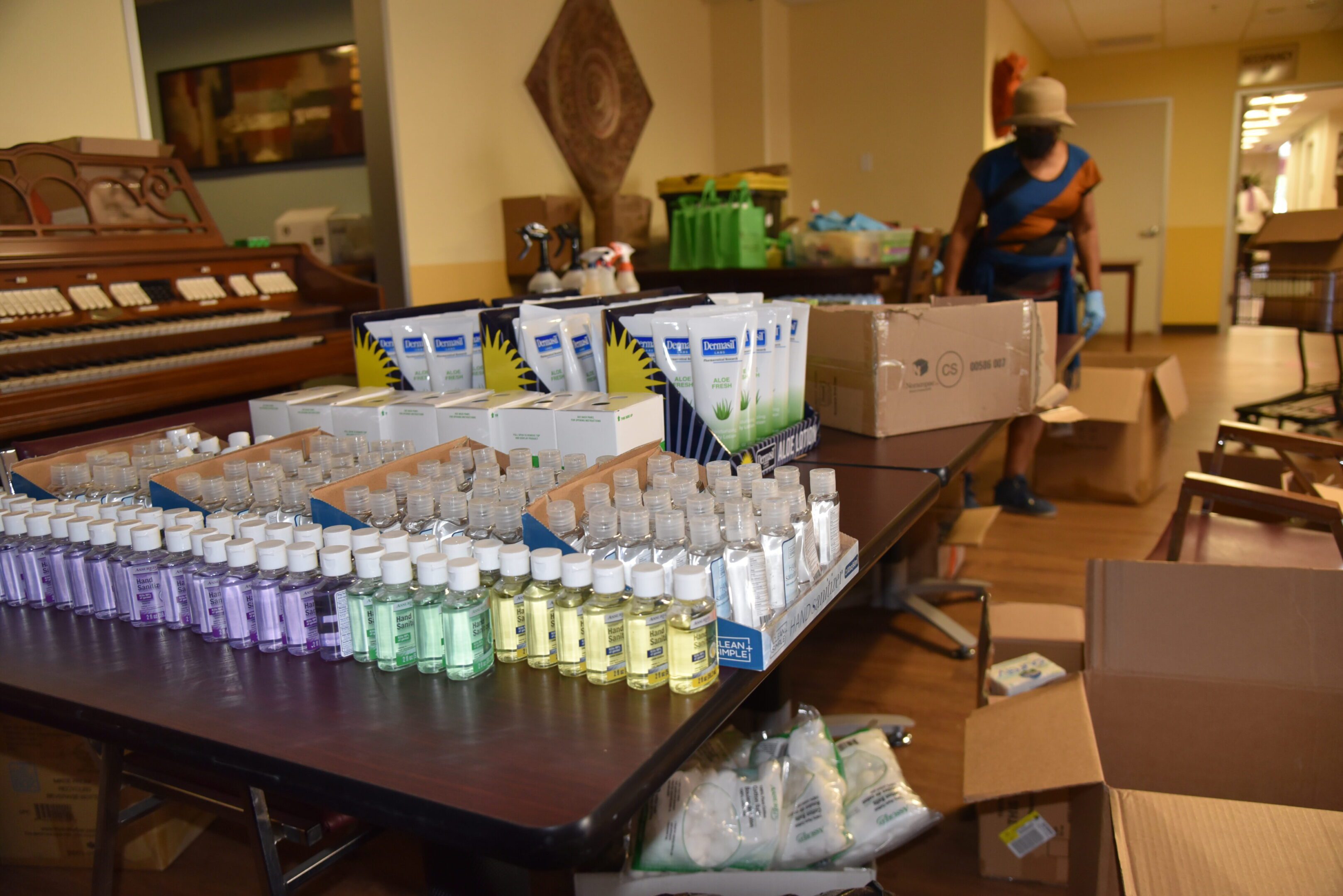 Hand sanitizers and toiletries on display table.