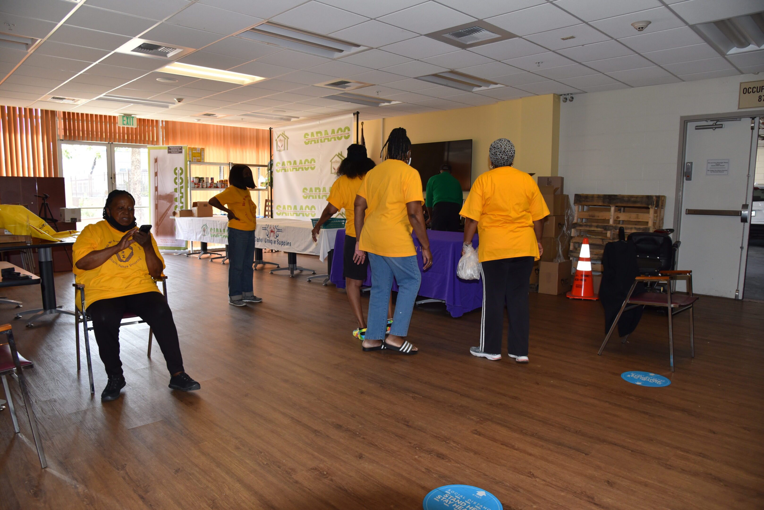 People in a room wearing yellow shirts.