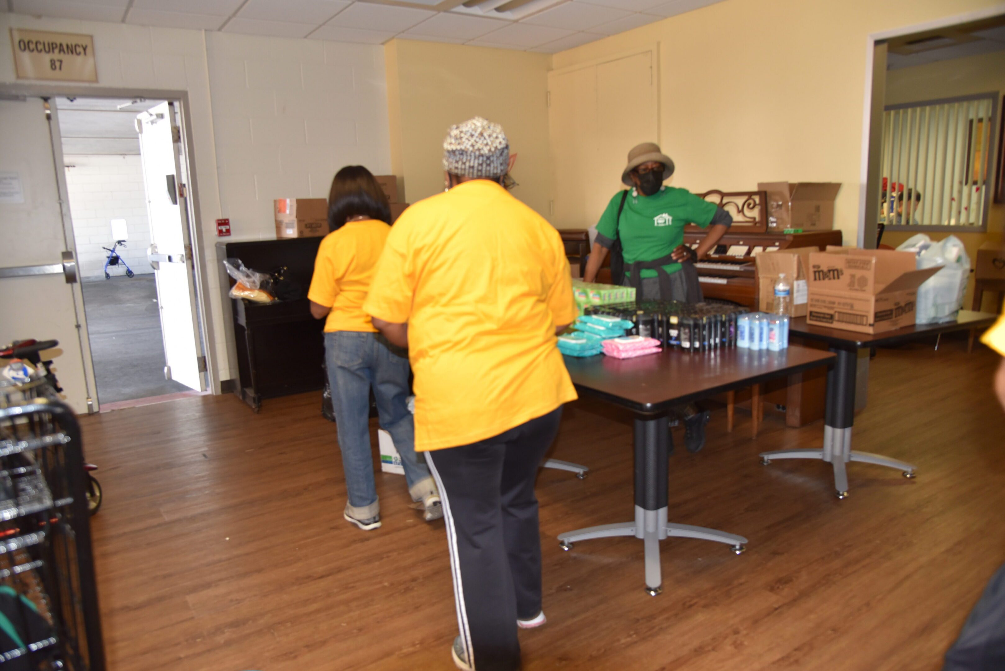 Volunteers organizing supplies in a community center.