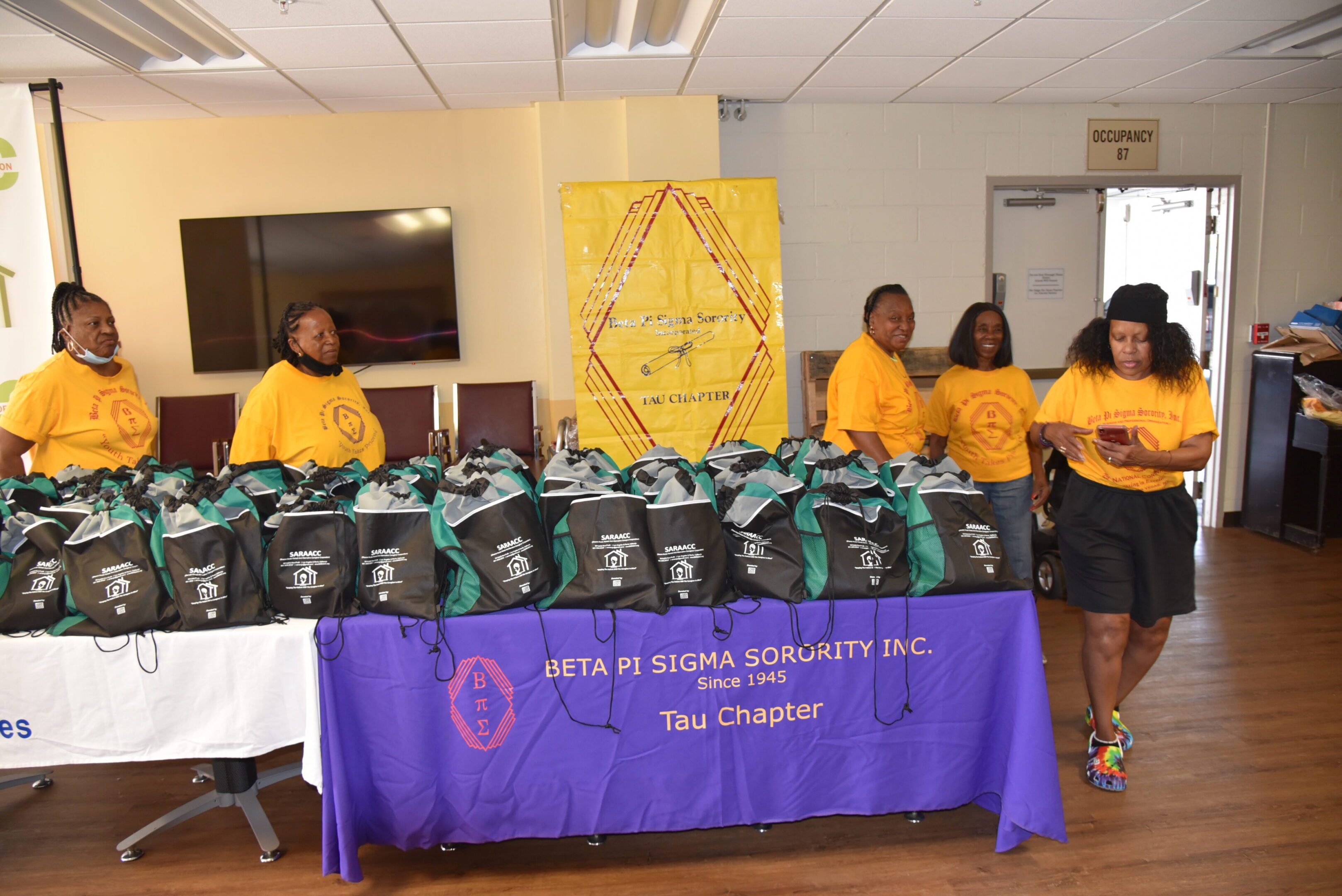 Group preparing bags at sorority event.