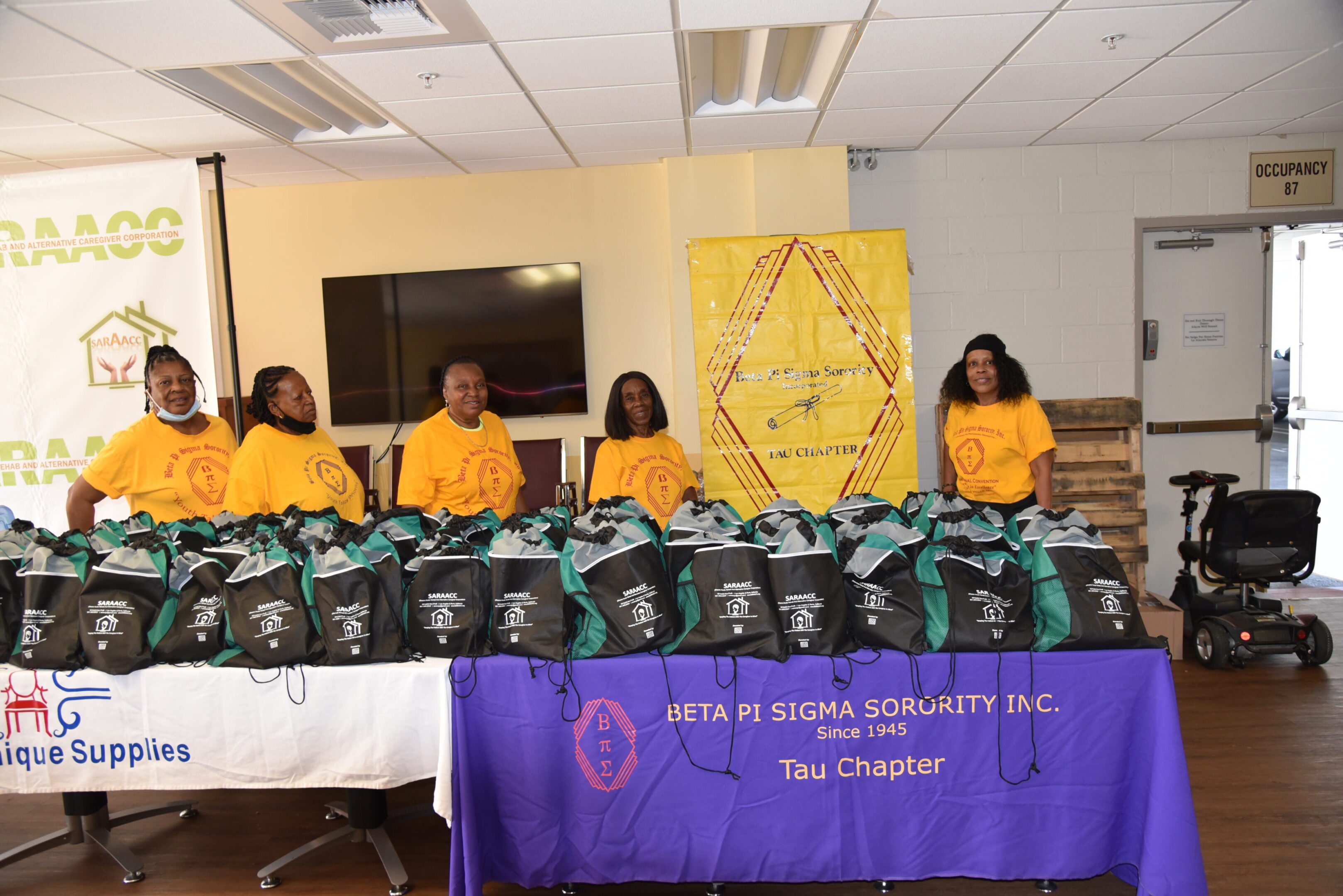 Group of women with donated backpacks.