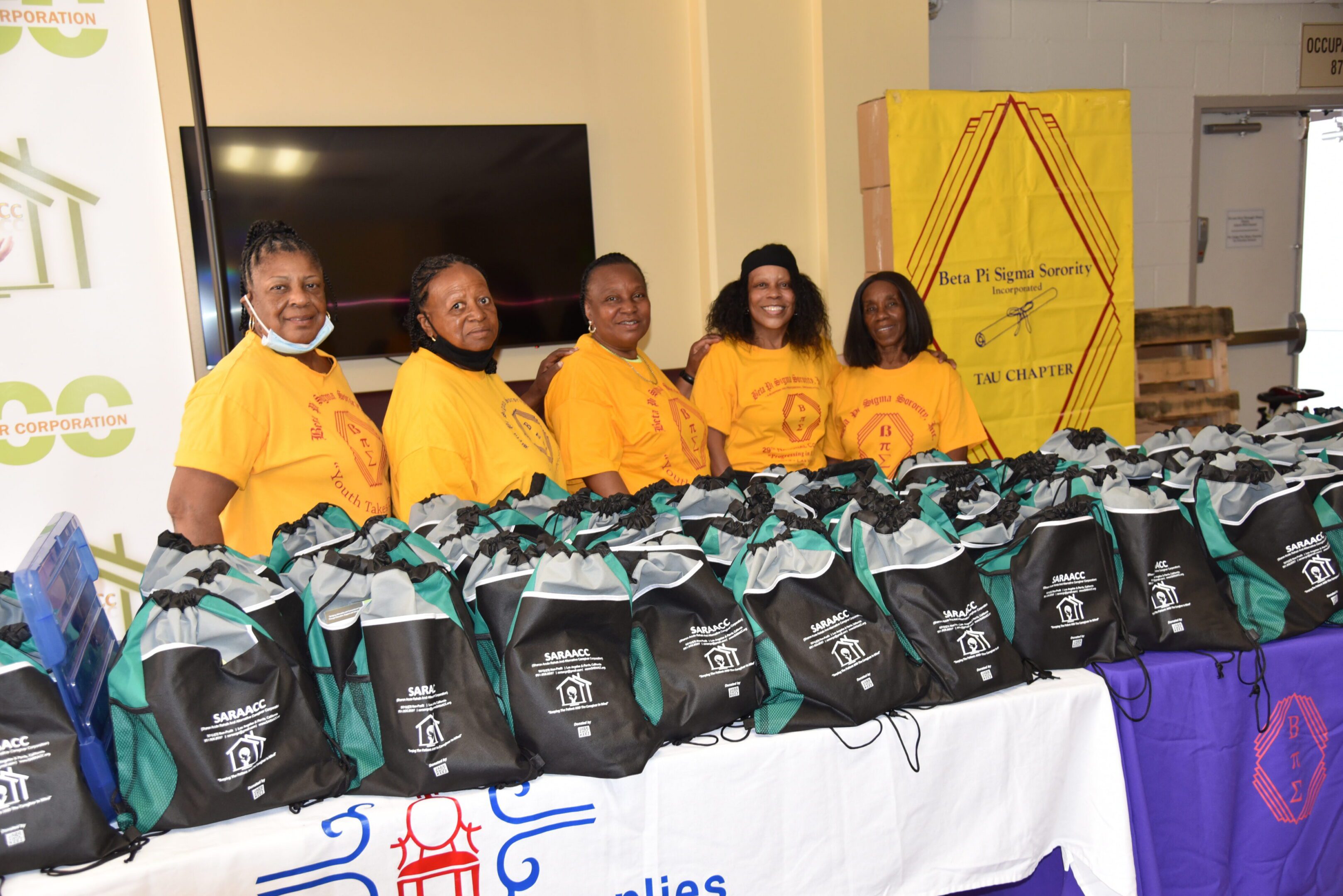 Group of women with charity bags displayed.