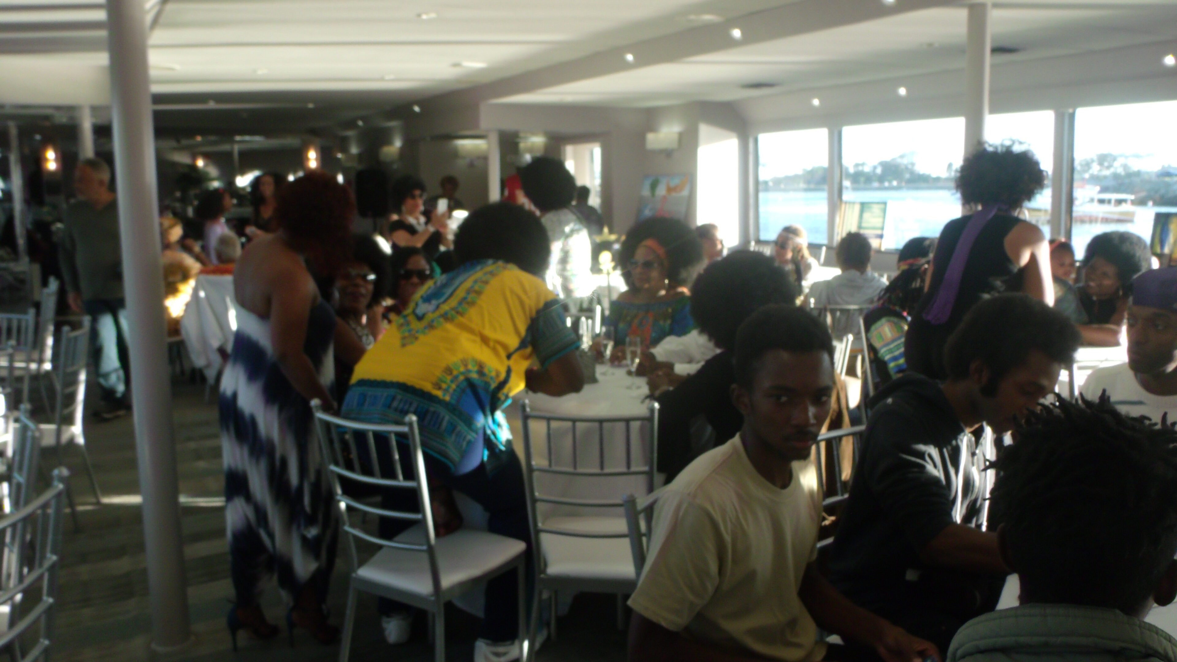 People socializing at a crowded indoor event.