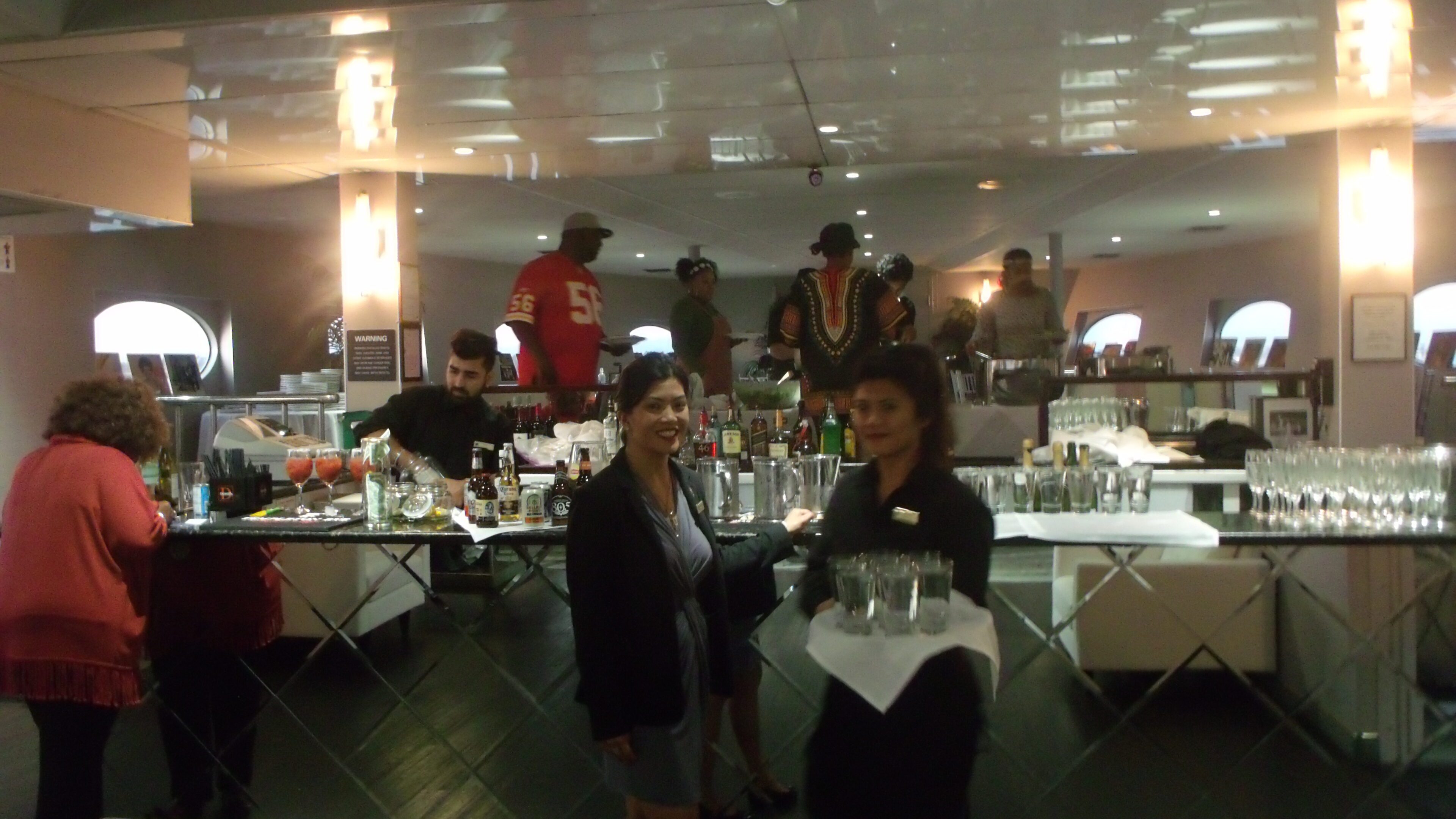 People socializing at a busy indoor bar.