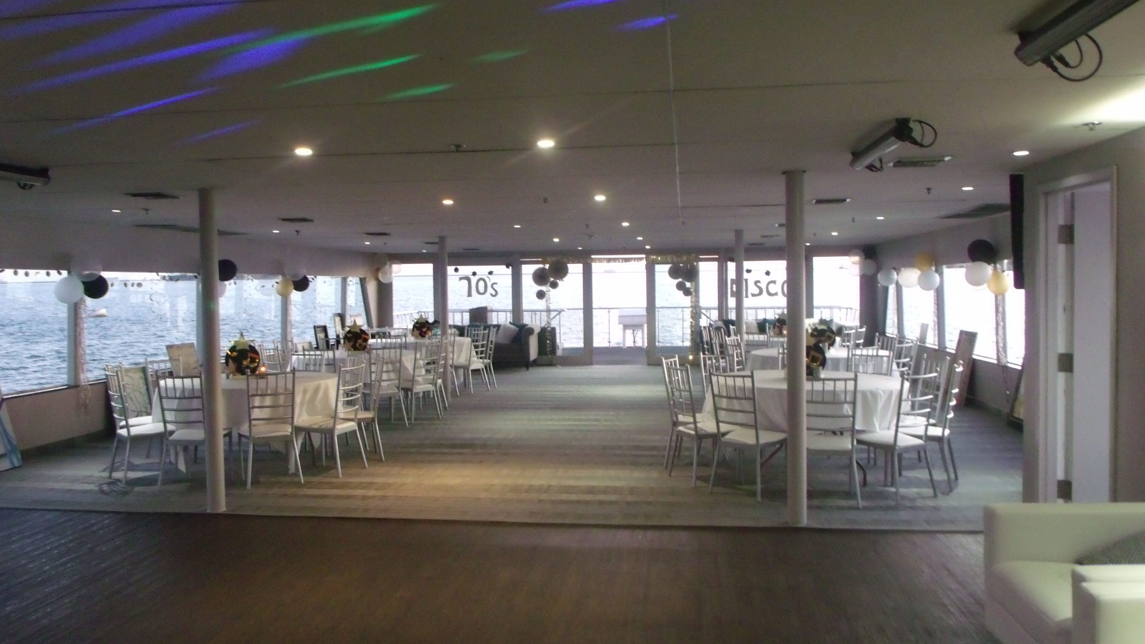 Spacious event hall with tables and chairs.