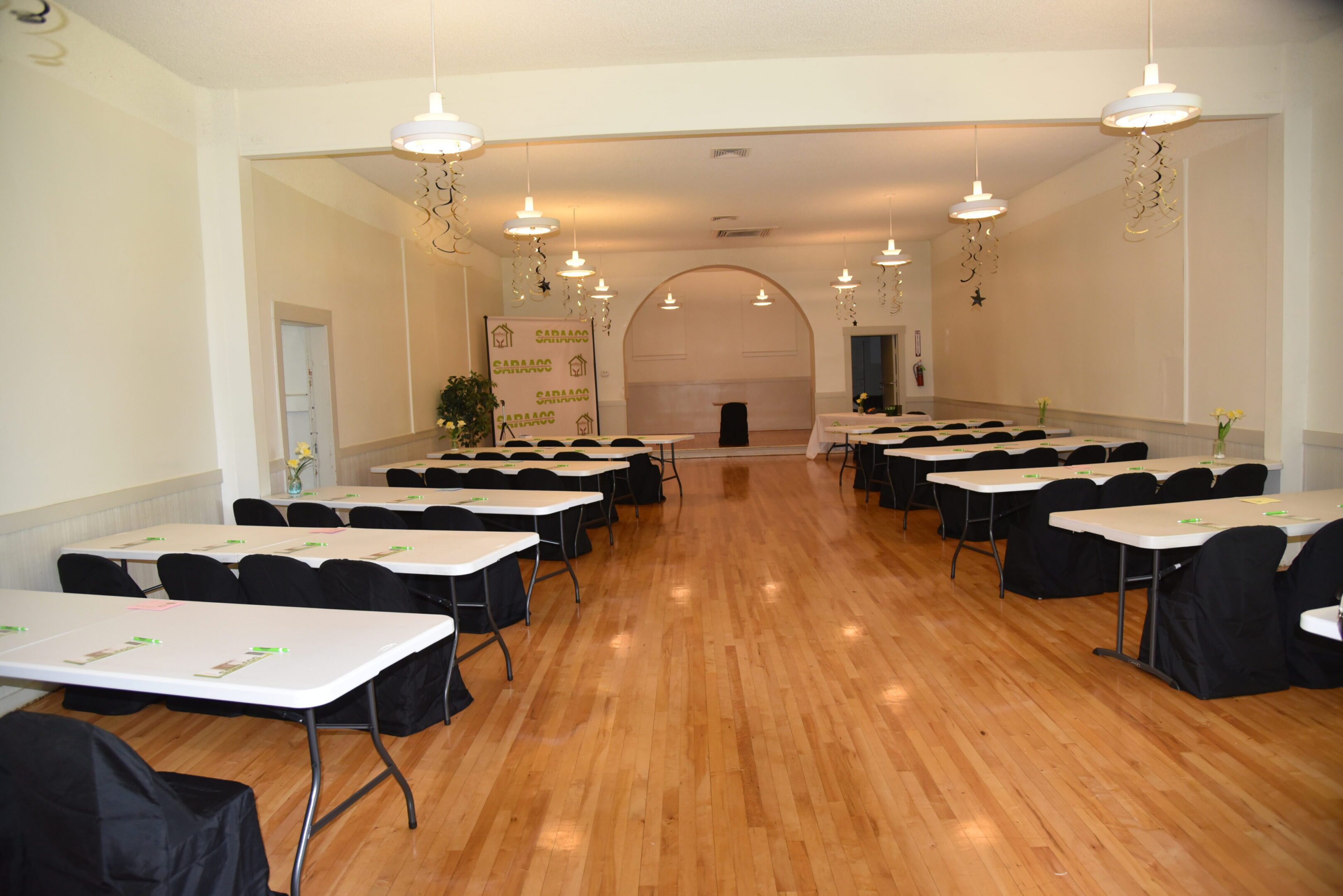 Empty event hall with arranged tables.