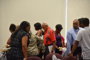 People gathering around a table, socializing.
