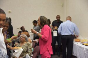 People socializing and eating at a gathering.