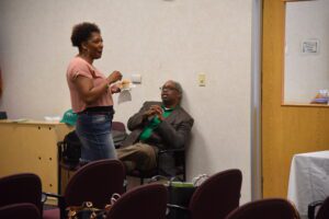 Two people talking in a small room.