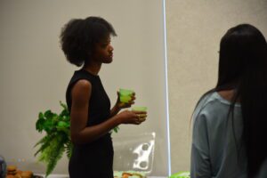 Two people talking at a gathering.
