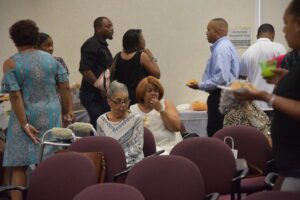 People socializing at indoor gathering event.