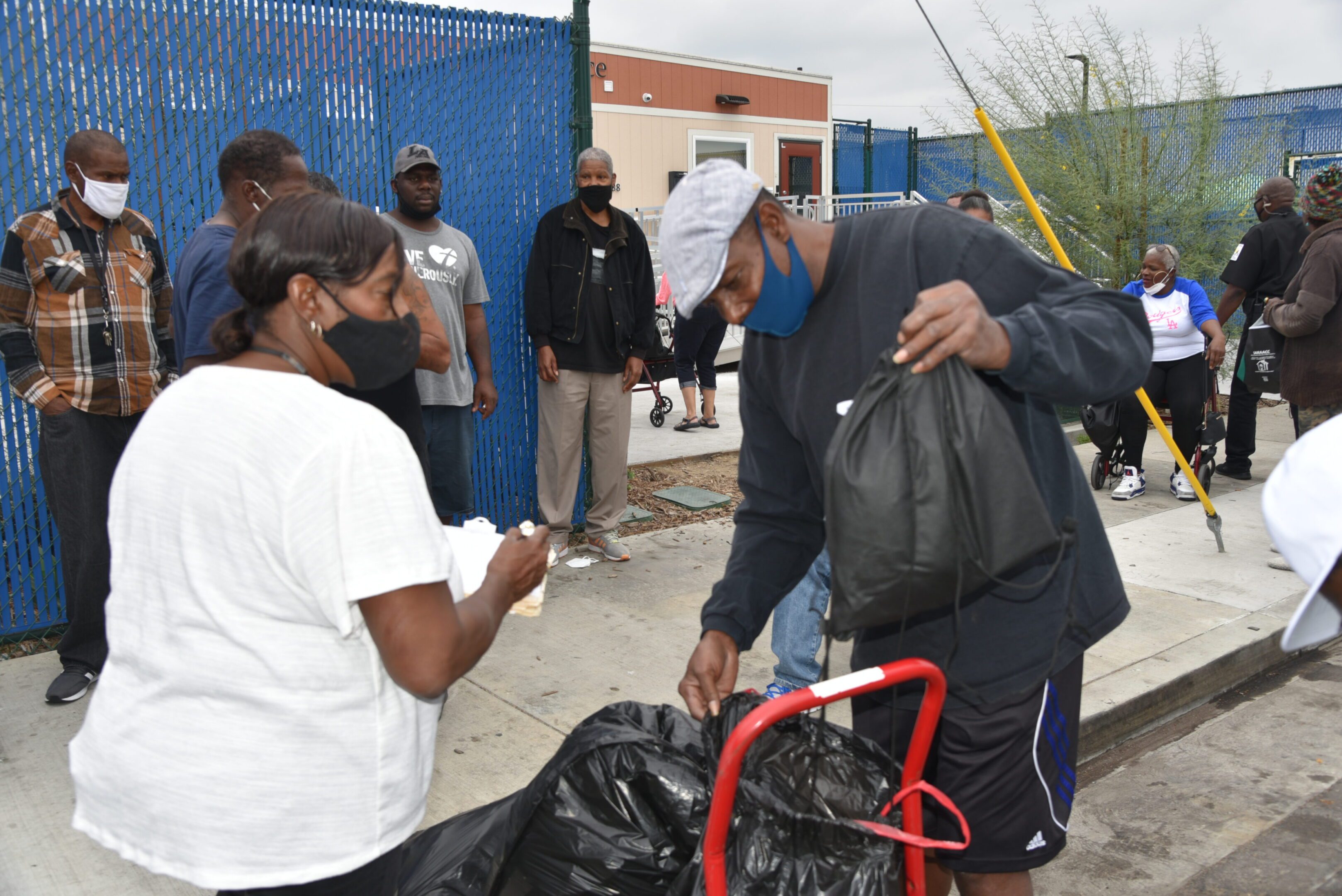 People distributing supplies at an outdoor event.