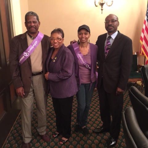 Group photo in formal setting with flag.
